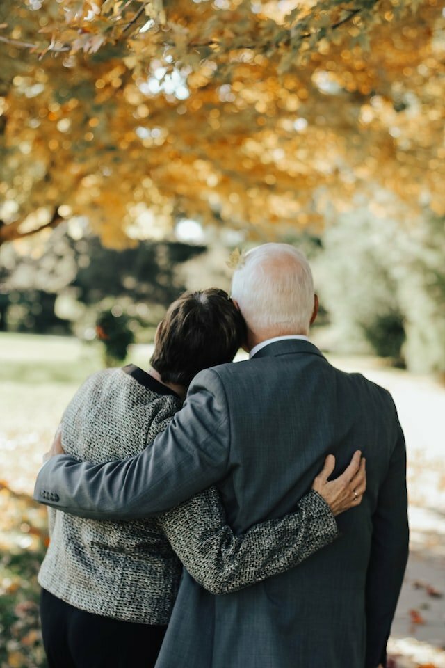 Decorative image: Mature couple with arms around each other, facing away from viewer